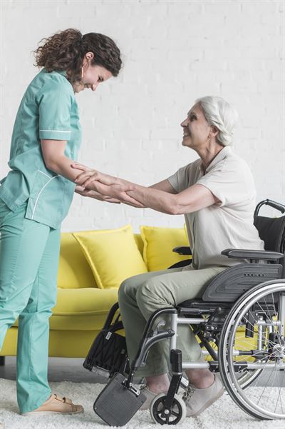 caregiver-helping-senior-female-patient-sitting-wheel-chair